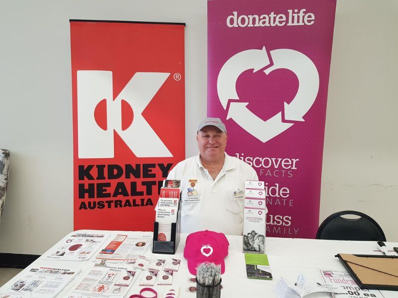 A man poses at a Kidney Health Australia event stall