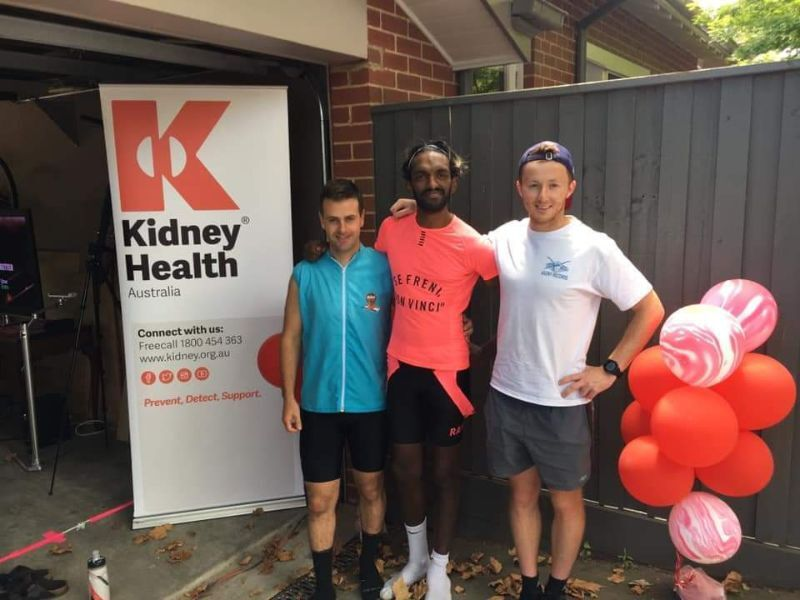 Inesh stands with two others in front of a Kidney Health Australia banner