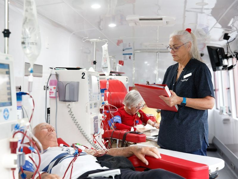 Two dialysis patients and a health professional on the bid red kidney bus