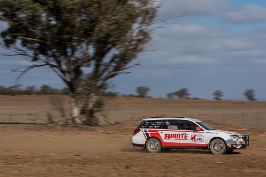 A car racing through the desert in the Kidney Kar Rally