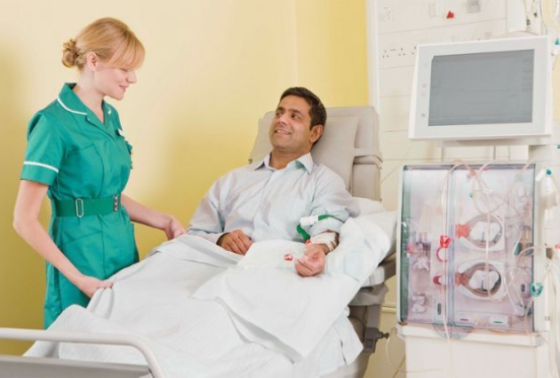 A nurse consults with a man on dialysis