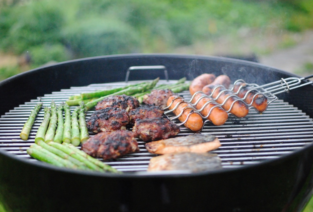Meat and asparagus cooking on a barbeque