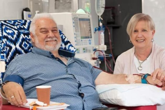 Ian on dialysis with wife Georgina on the Big Red Kidney Bus