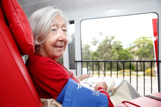 An older female dialysis patient on the big red kidney bus